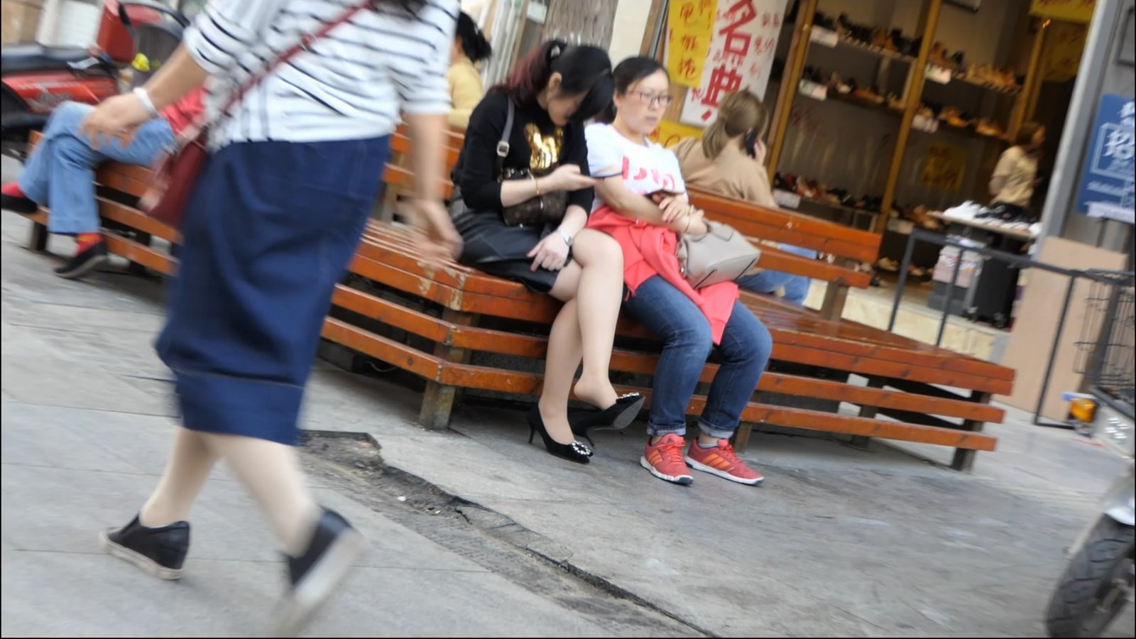 Beautiful woman with dangling legs and a sporty woman